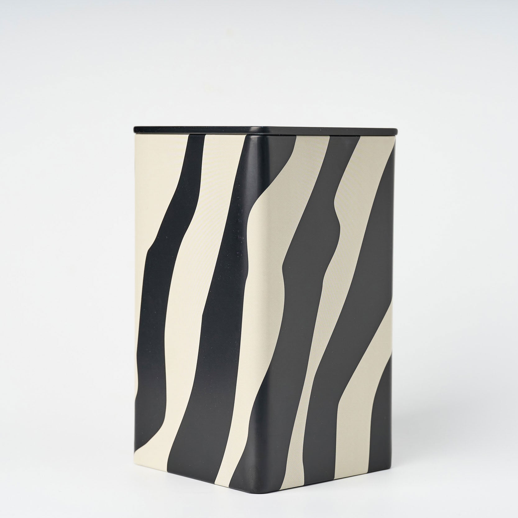 Rectangular container with black and white zebra stripe pattern on a white background